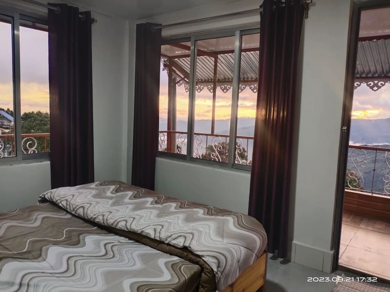 Rhododendron room at Roshni Home Stay, with attached bathroom and hill view